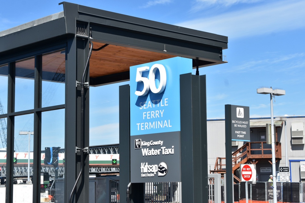The main exterior pylon sign for Colman Dock's Pier 50 walk-on passenger ferry terminal features aluminum, acrylic and pan halo illuminated letters.