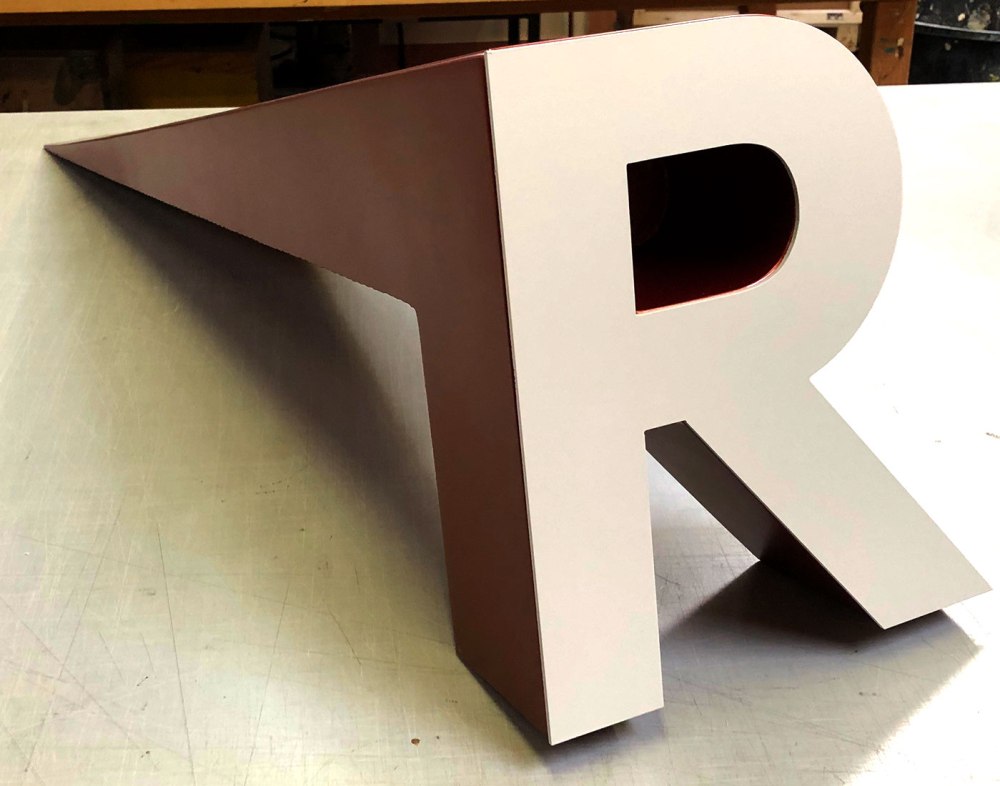 The main entrance will feature dramatically tapered 48" dimensional letters finished in a bronze metallic paint and flush mounted letters on the exterior soffit.